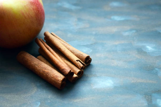 istock Apple and cinnamon on wooden background. Ingredients for baking. Rustic still life. 1128630907