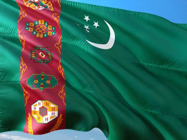 Photo of Flag of Turkmenistan waving in the wind against deep blue sky. High quality fabric.