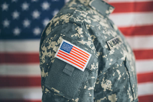 istock USA flag and US Army patch on solder's uniform 1128632138