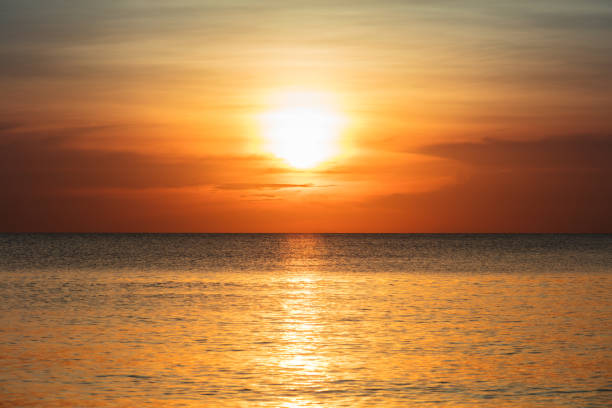 istock beautiful sunset over the tranquil ocean 1128632204