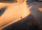 Woman walking in the desert aerial view