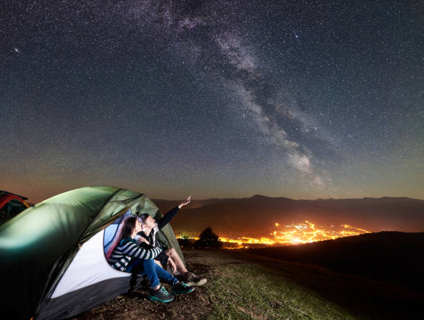 istock Couple tourists resting at night camping under stars 1128633150