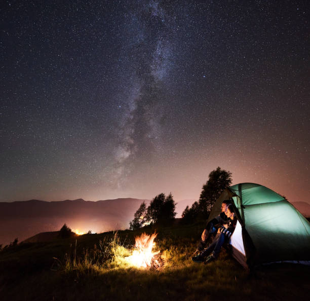 istock Couple tourists resting at night camping under stars 1128633161
