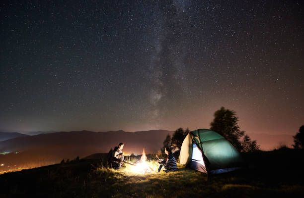 istock Couple tourists resting at night camping under stars 1128633165
