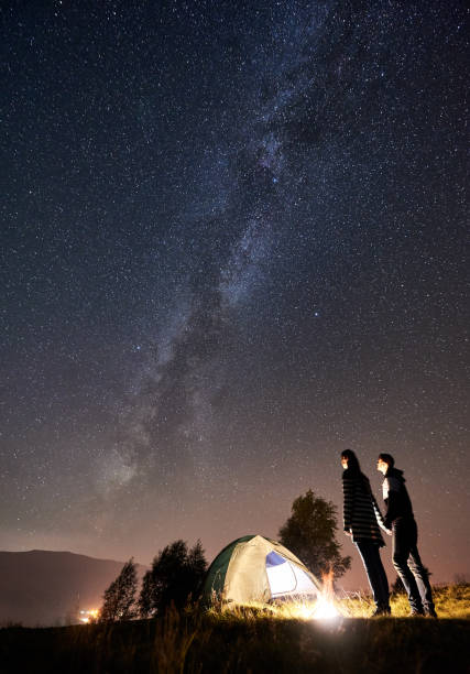 istock Couple tourists resting at night camping under stars 1128633168
