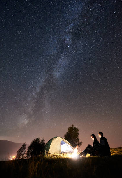 istock Couple tourists resting at night camping under stars 1128633174