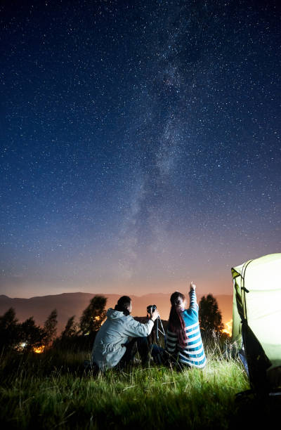 istock Couple tourists resting at night camping under stars 1128633183