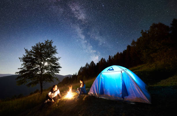 istock Couple tourists resting at night camping under stars 1128633190