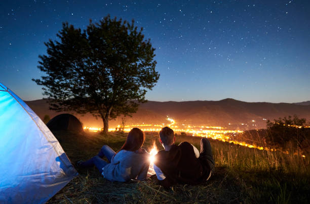 istock Couple tourists resting at night camping under stars 1128633192