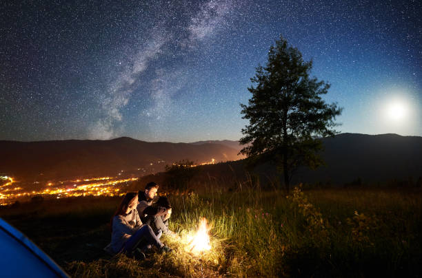 istock Couple tourists resting at night camping under stars 1128633204