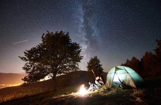 istock Couple tourists resting at night camping under stars 1128633205