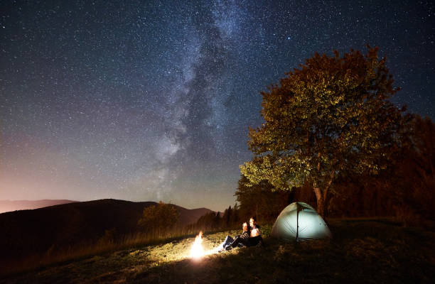istock Couple tourists resting at night camping under stars 1128633212