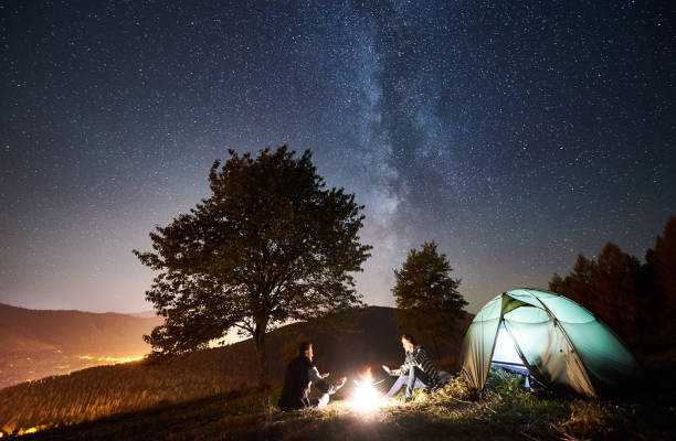 istock Couple tourists resting at night camping under stars 1128633223