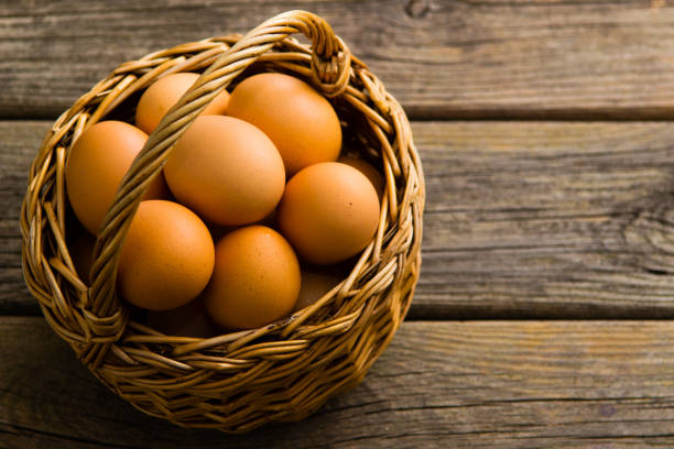 istock Basket of egg on weathered wooden table 1128633351