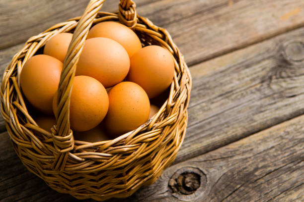 istock Basket of egg on weathered wooden table 1128633484