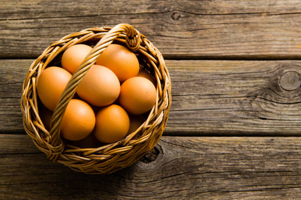 istock Basket of egg on weathered wooden table 1128633683