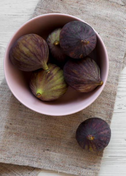 istock Fresh figs in a pink bowl on cloth. Top view, overhead, from above. 1128634655