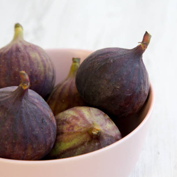 istock Fresh figs in a pink bowl, side view. Close-up. Selective focus. 1128634729