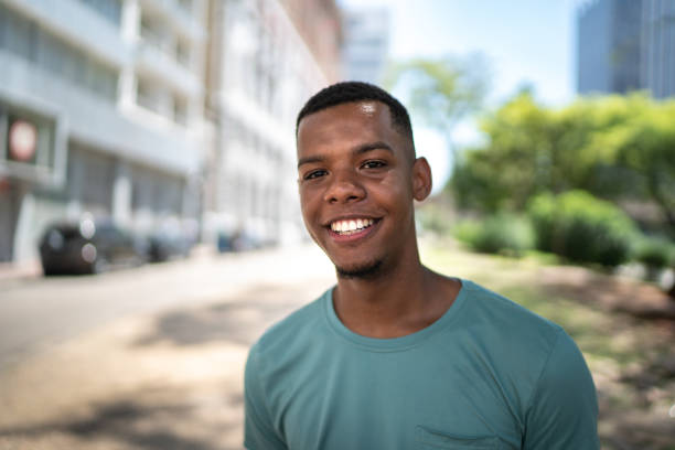 istock Afro young man in the city portrait 1128635678