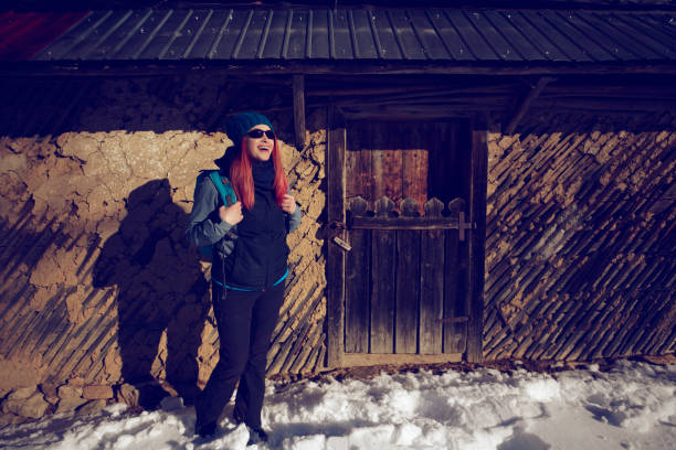 istock young woman near old house 1128635768