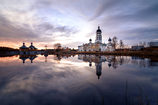 istock Krypetsky monastery at sunset reflected in the lake. 1128635901