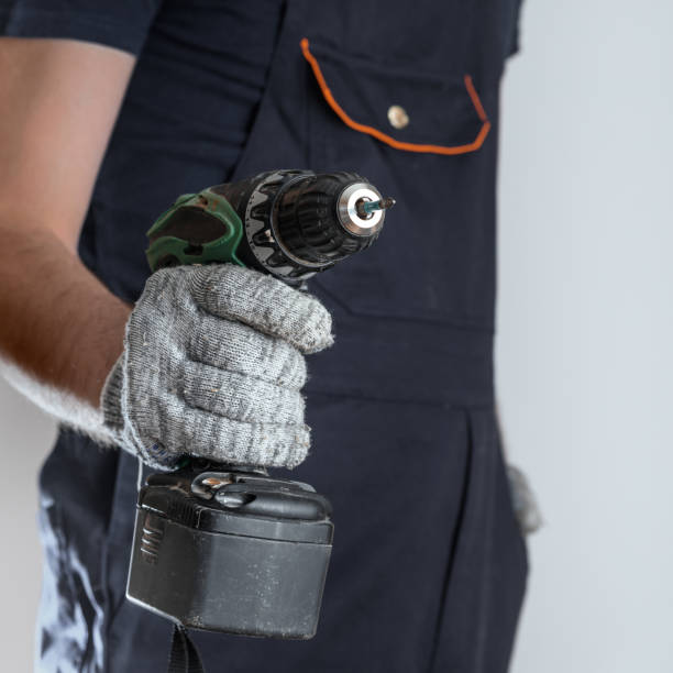 istock Crop working man holding a screwdriver. The man in the blur. 1128635953