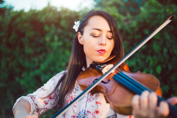 istock Girl violinist in nature 1128636807