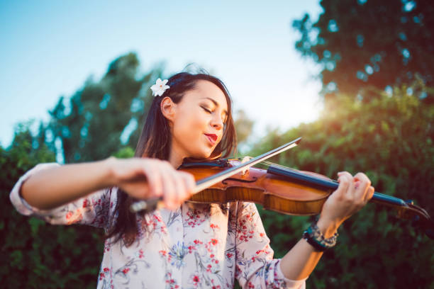 istock Girl violinist in nature 1128636894