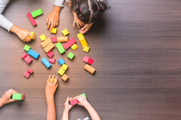 istock Kids and teacher playing on table 1128637396
