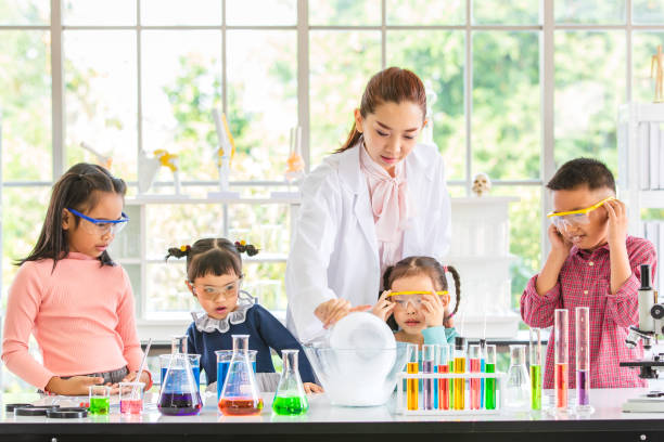 istock Teacher teach students about chemicals in lab. 1128637432