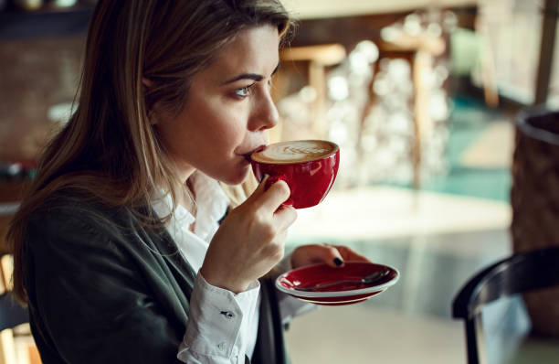 istock Beautiful pensive woman drinking coffee in a cafe. 1128638552