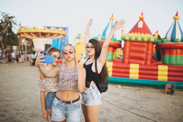 istock Girls taking selfies by inflatable castle 1128639457