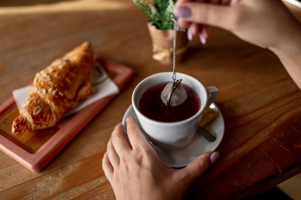 istock Close up of woman making tea. 1128639802