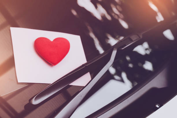 istock love letter heart on a sticky note under a windshield .vintage  color style 1128646036