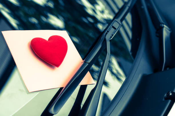 istock love letter heart on a sticky note under a windshield .vintage  color style 1128646058