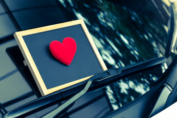 istock love letter heart on a sticky note under a windshield .vintage  color style 1128646097