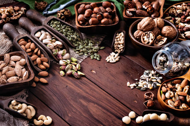 istock Variety of dried fruit and nuts on a table in a old fashioned rustic kitchen 1128647514
