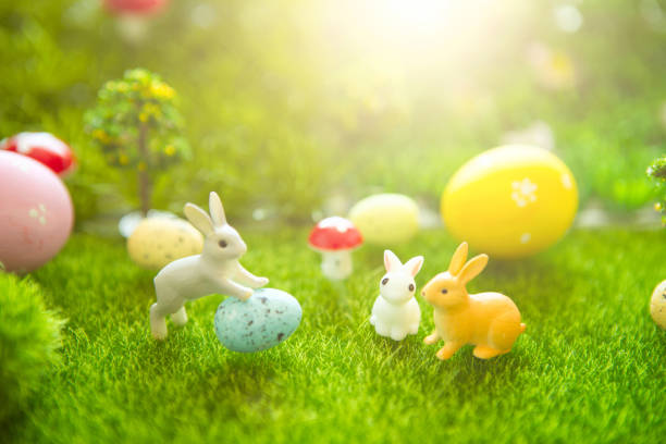 istock Easter rabbits on green grass with Easter eggs in Dreamland or fairy world 1128648420