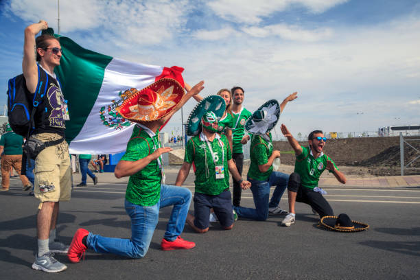 football fans of Mexico in Russia ROSTOV-ON-DON, RUSSIA - 07/17/2018:Mexican fans in suits and sambreros are photographed with the national flag rostov on don stock pictures, royalty-free photos & images