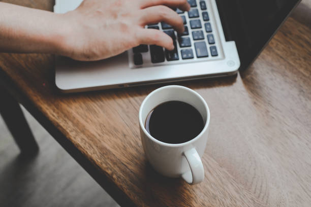 istock Fresh coffee , work on computer , laptop, notebook,  while sitting on wooden desk 1128650447