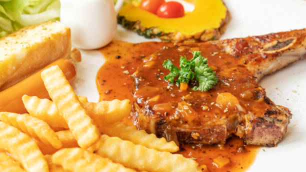 istock Pork Chop steak on a white plate. 1128652043