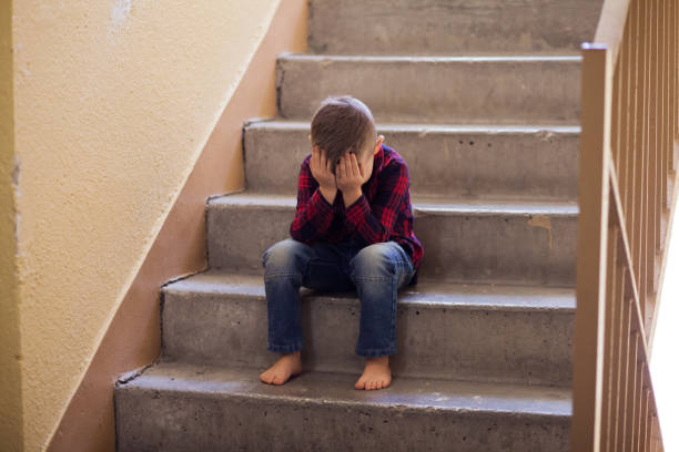 istock Distraught boy in stairwell 1128653735