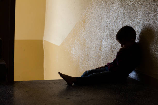 istock Distraught boy in stairwell 1128653759