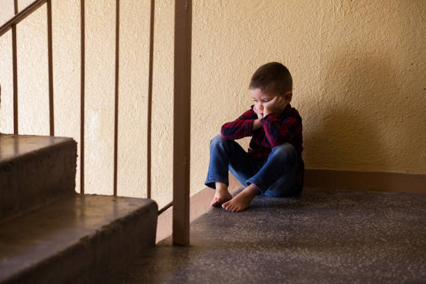 istock Distraught boy in stairwell 1128653816