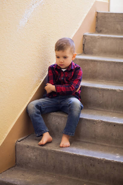 istock Distraught boy in stairwell 1128653844