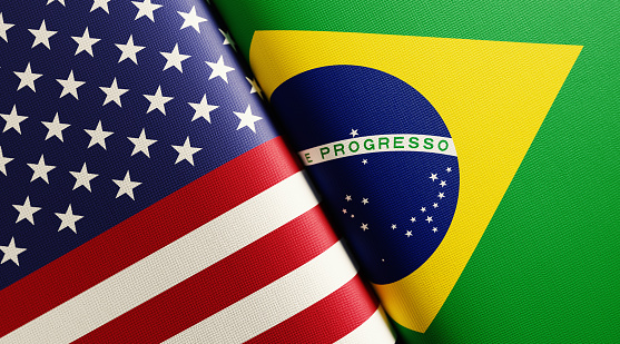 American and Brazilian flag pair. Horizontal composition with copy space and selective focus.