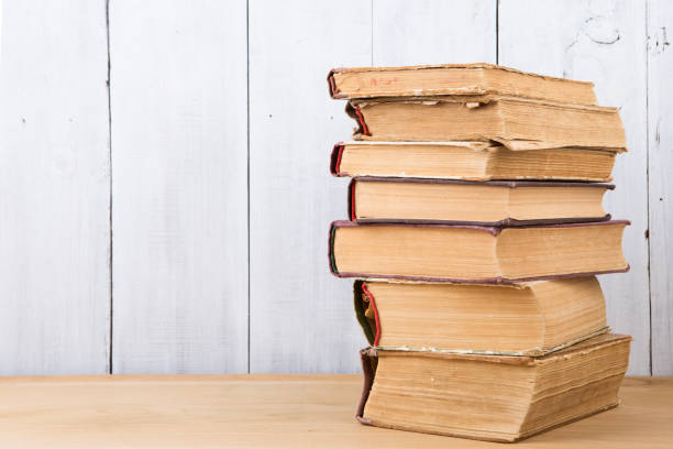 istock stack of books on the desk over wooden background 1128654800