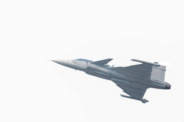 istock The Gripen plane above the horizon 1128655012