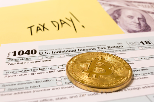 Bitcoin coin with 1040 income tax form for 2018 for filing on April 15. Slovenia, January 12, 2019
