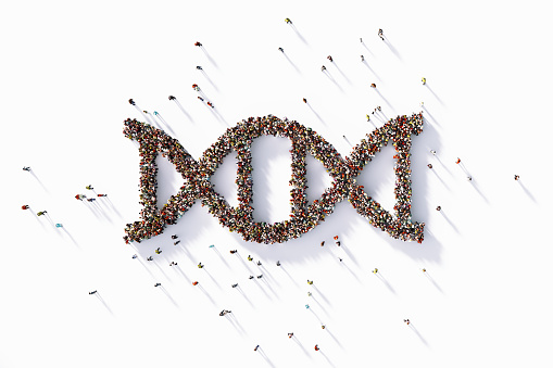 Human crowd forming a big DNA symbol on white background. Horizontal composition with copy space. Clipping path is included.